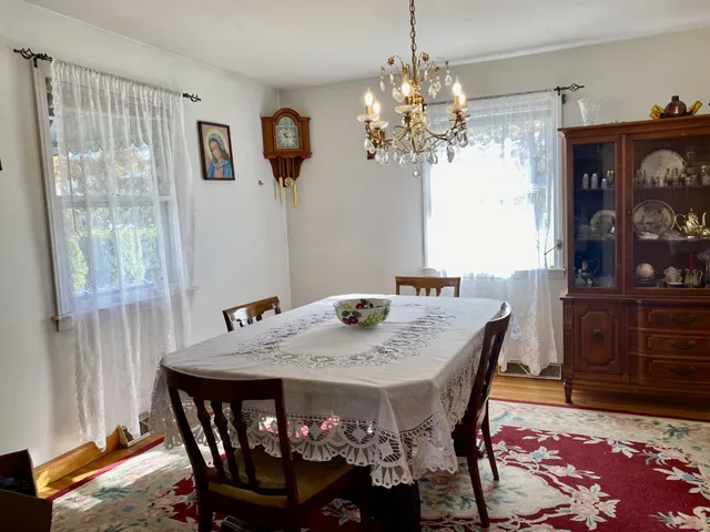 a view of a dining room with furniture wooden floor and chandelier