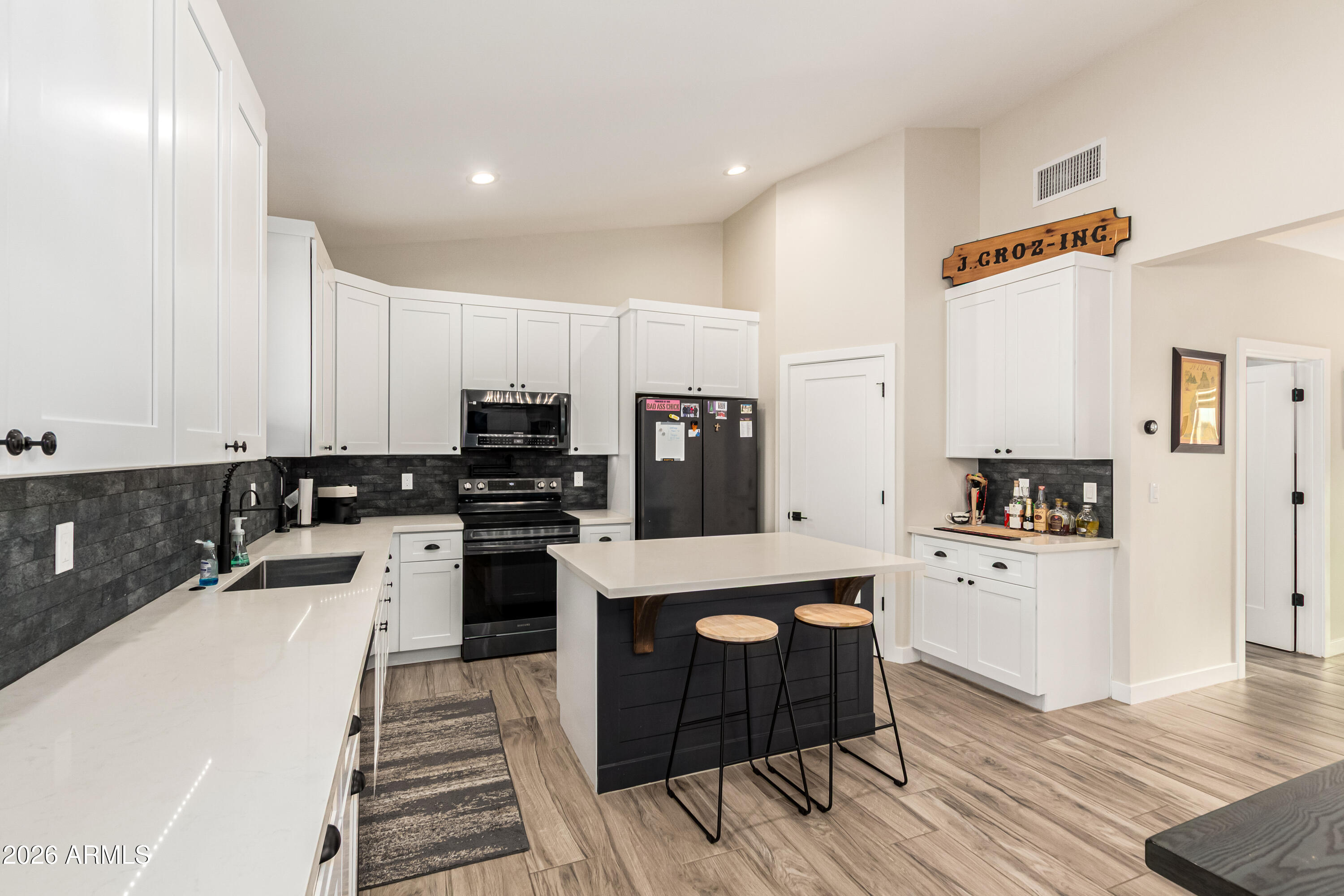 990 North Muleshoe Road Apache Junction, AZ 85119 - Photo 14 of 34 a large kitchen with cabinets wooden floor and stainless steel appliances