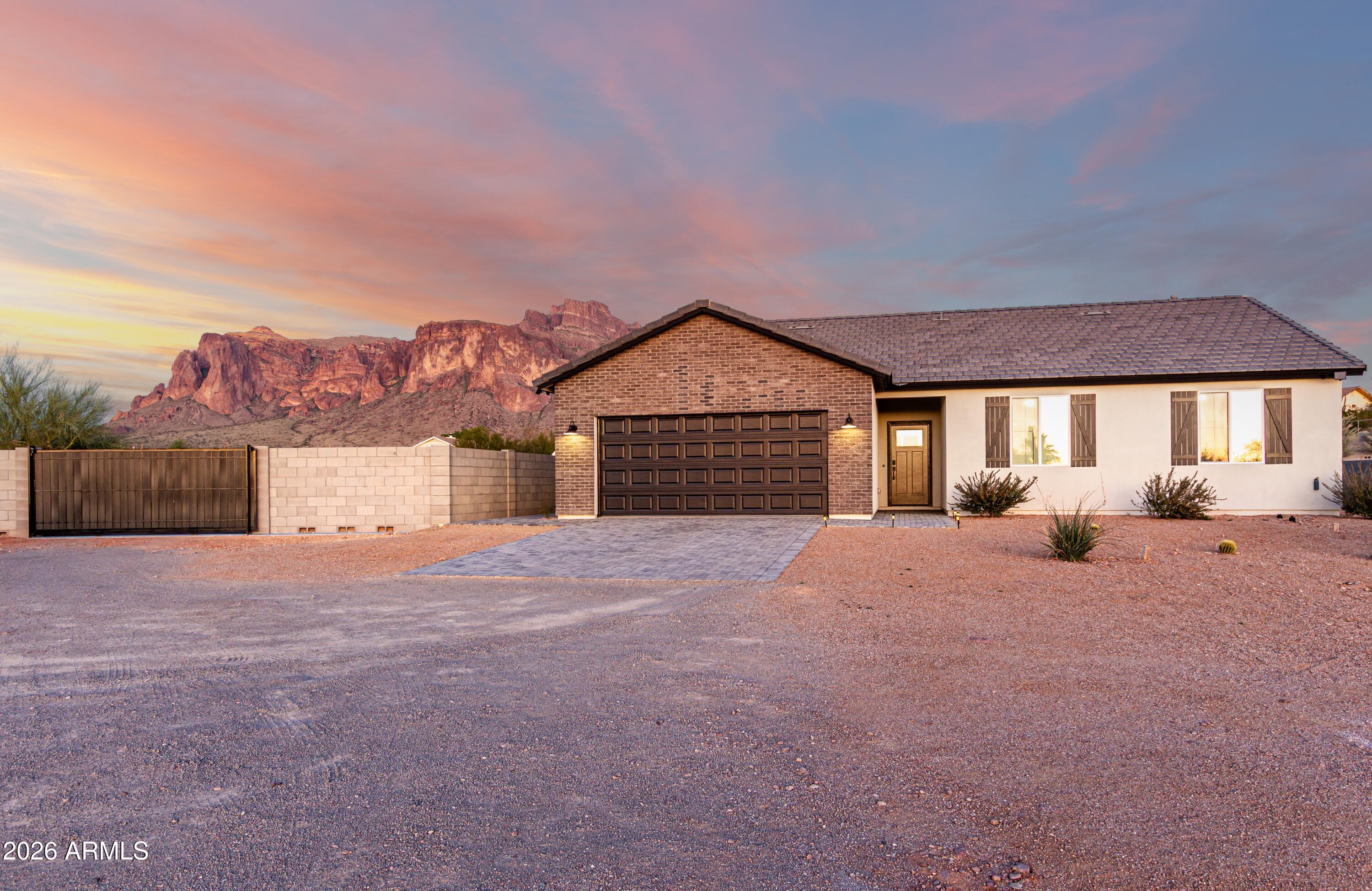 990 North Muleshoe Road Apache Junction, AZ 85119 - Photo 2 of 34 a front view of a house with a yard and garage