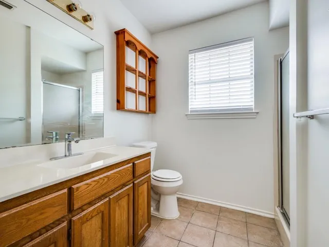 a bathroom with a sink a toilet and mirror