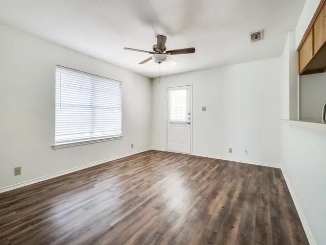 wooden floor in an empty room with a window