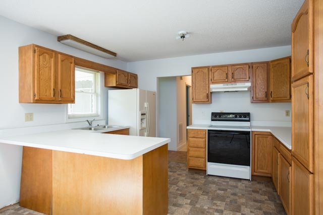 239 South River Road Grottoes, VA 24441 - Photo 6 of 25 a kitchen with stainless steel appliances granite countertop a sink stove and refrigerator
