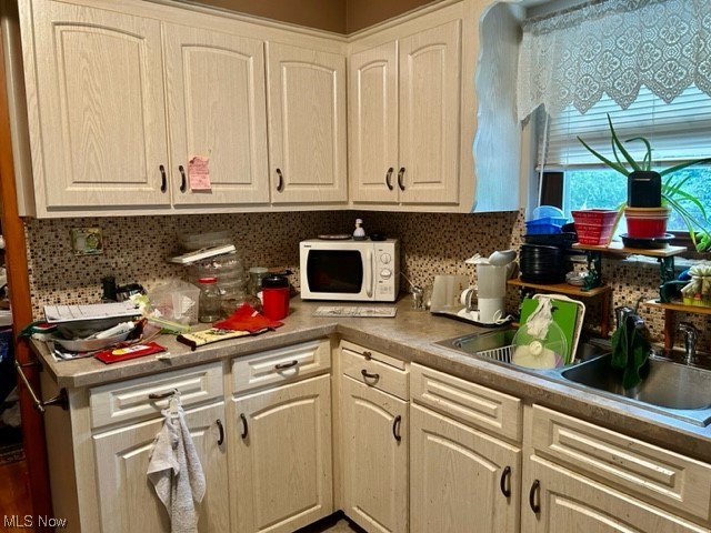 6833 East Pleasant Valley Road Independence, OH 44131 - Photo 11 of 30 Kitchen with backsplash and dark countertops