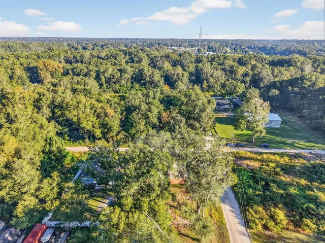 an aerial view of residential houses with yard