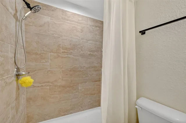 a bathroom with a shower and a toilet