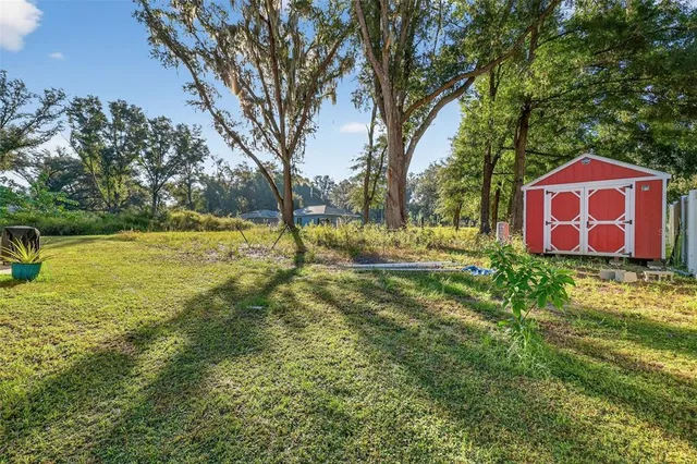 a view of outdoor space with garden and trees