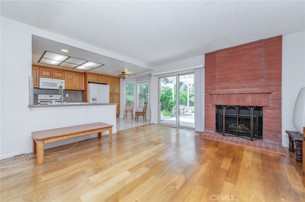 19621 Running Brand Circle Walnut, CA 91789 - Photo 16 of 40 a view of livingroom with furniture a fireplace and wooden floor