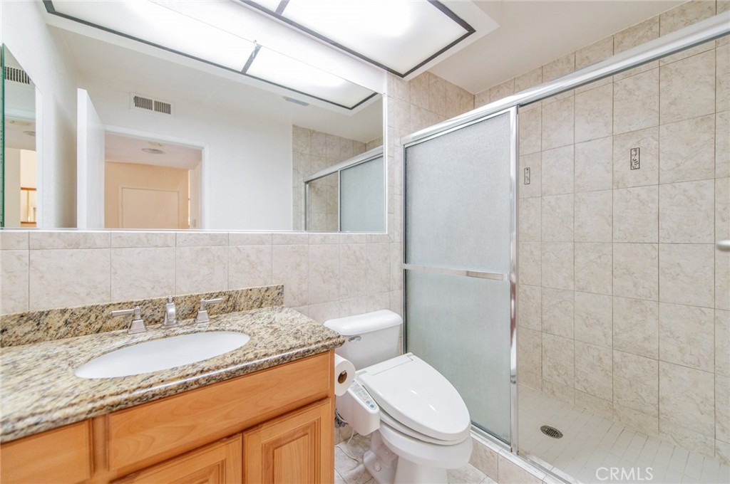 19621 Running Brand Circle Walnut, CA 91789 - Photo 32 of 40 a bathroom with a granite countertop sink a toilet and shower