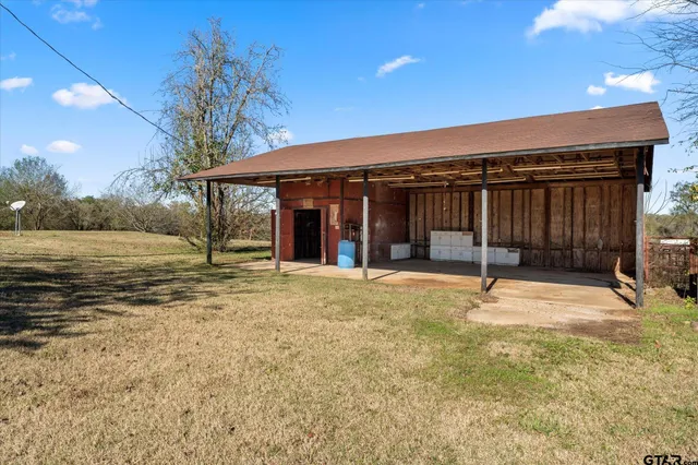 a view of a house with a yard covered in snow