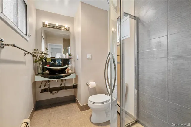 a bathroom with a toilet a sink and a mirror