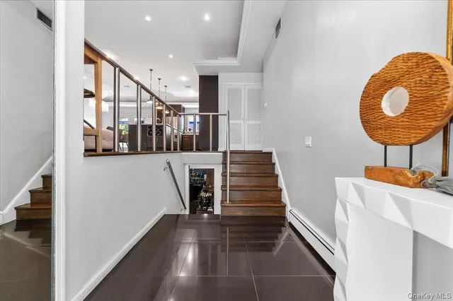 a view of entryway and hall with wooden floor