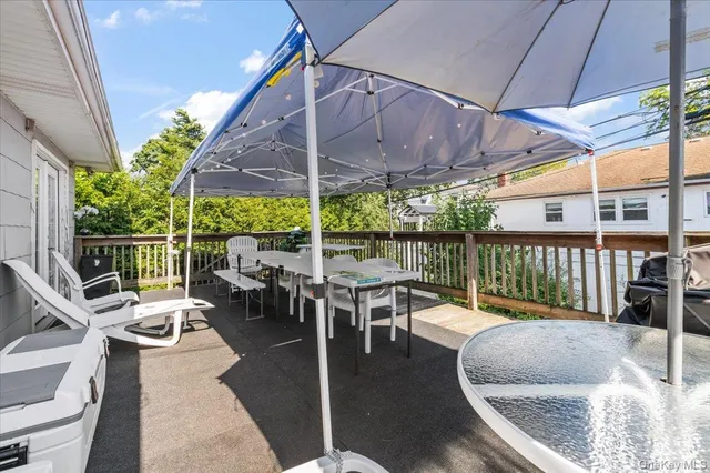 a view of a patio with a table chairs and a potted plant