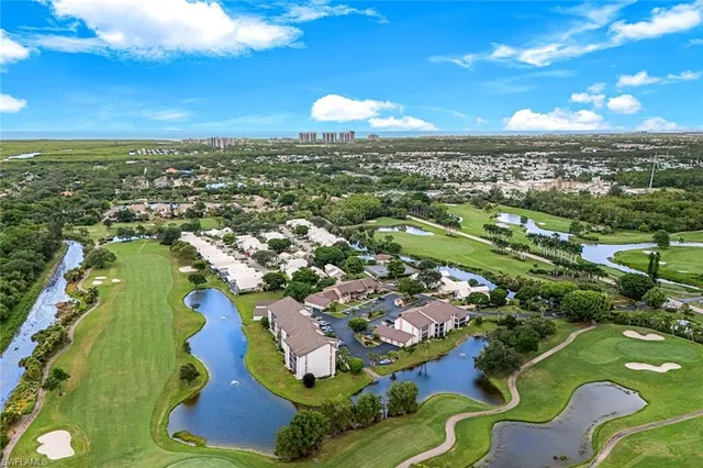 an aerial view of residential houses with outdoor space and river
