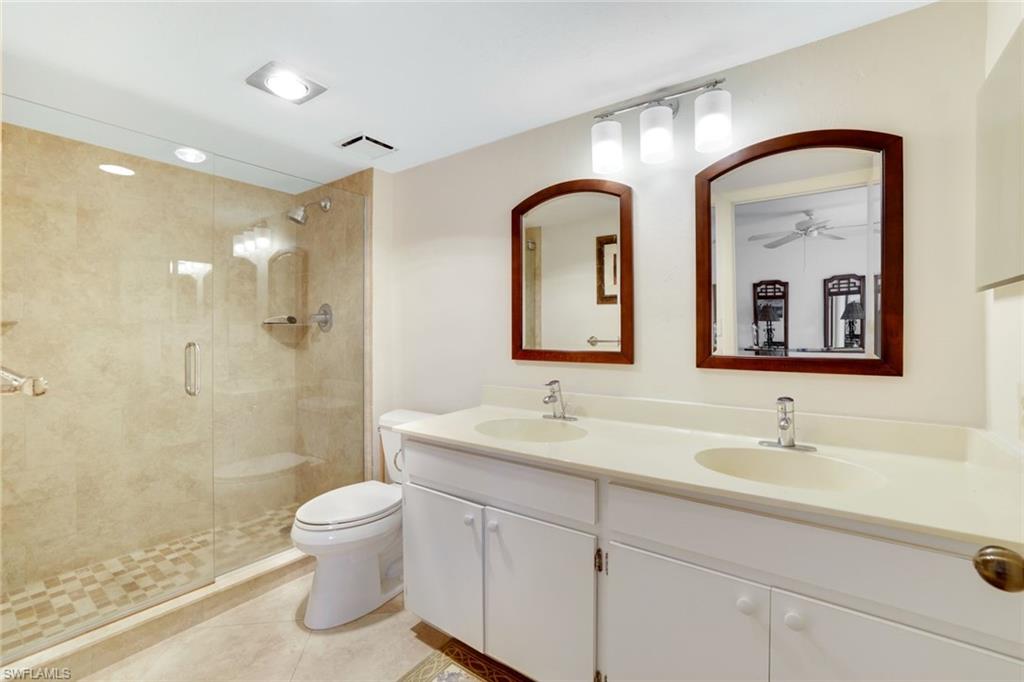 1510 Imperial Golf Course Boulevard, Unit 111 Naples, FL 34110 - Photo 15 of 21 a bathroom with a double vanity sink toilet and shower