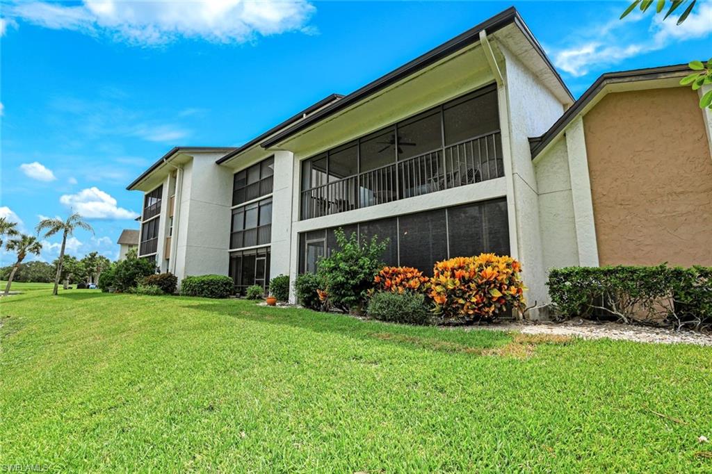 1510 Imperial Golf Course Boulevard, Unit 111 Naples, FL 34110 - Photo 18 of 21 a front view of a house with garden