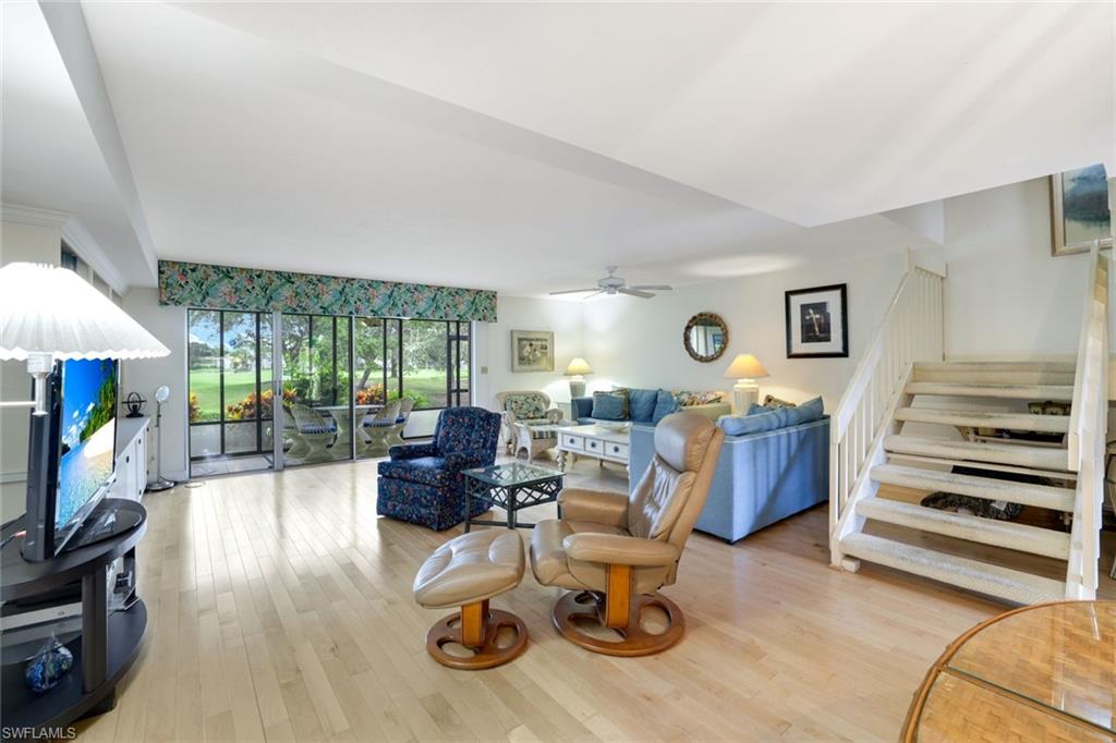 1510 Imperial Golf Course Boulevard, Unit 111 Naples, FL 34110 - Photo 4 of 21 a living room with furniture and a flat screen tv