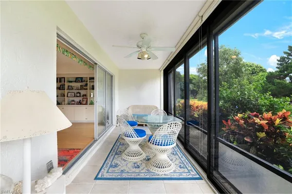 a living room with rug floor and a floor to ceiling window