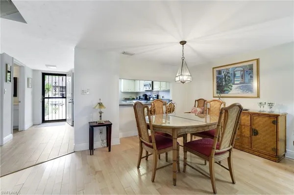 a view of a dining room with furniture window and wooden floor