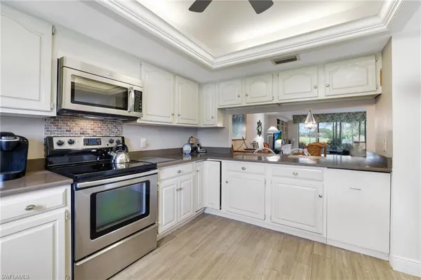 a kitchen with stainless steel appliances granite countertop a sink and a stove