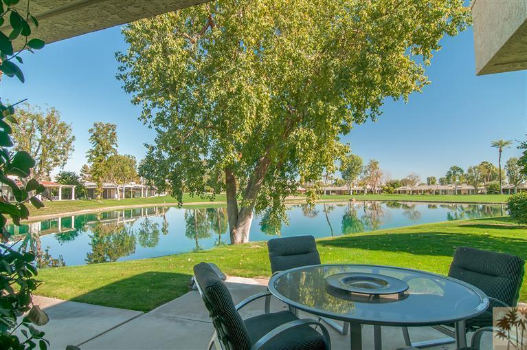 a view of lake with seating area and trees around