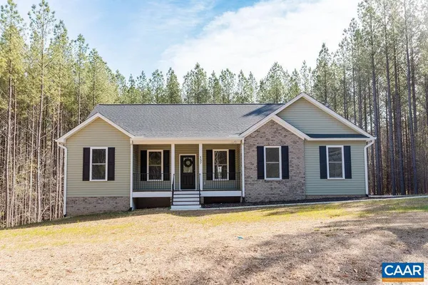 a front view of a house with a yard covered with snow in front of house
