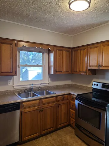 a kitchen with sink cabinets and stainless steel appliances