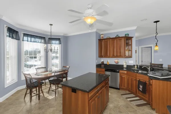 a kitchen with a stove a sink a dining table and chairs