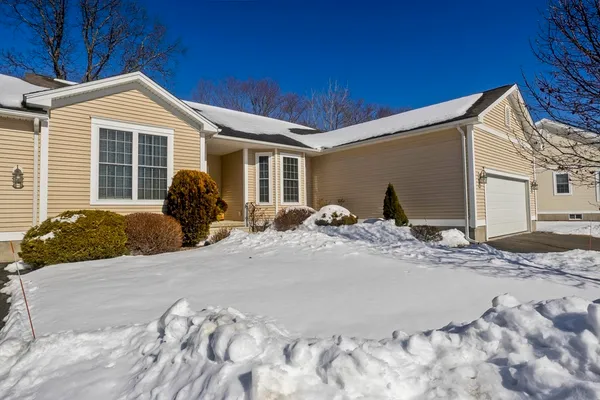 a view of a house with snow on the side of it