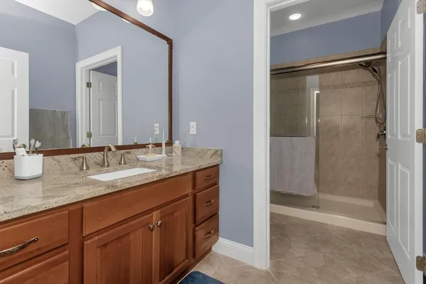 a bathroom with a granite countertop sink mirror and double
