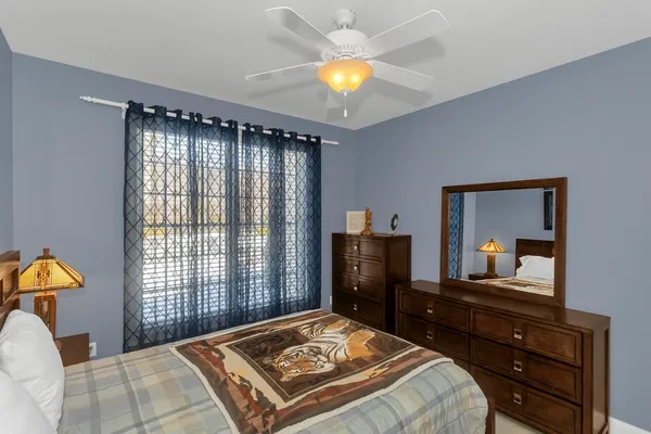 a bedroom with a bed and a dresser