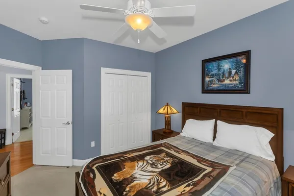 a bedroom with a bed and a chandelier