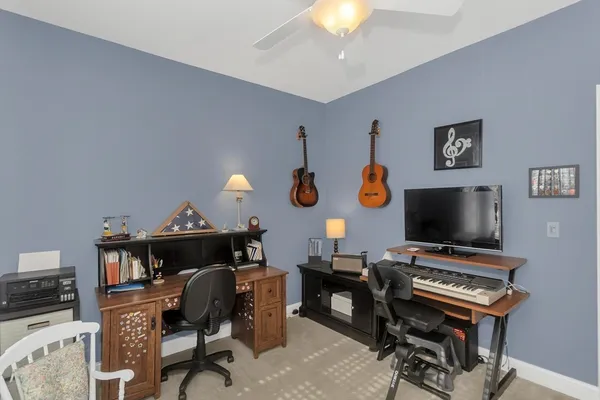 a view of a workspace with furniture and a flat screen tv