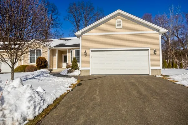 a view of a house with a yard and garage