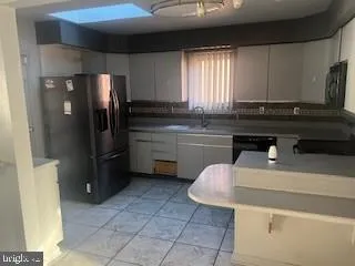 a kitchen with a sink appliances and cabinets