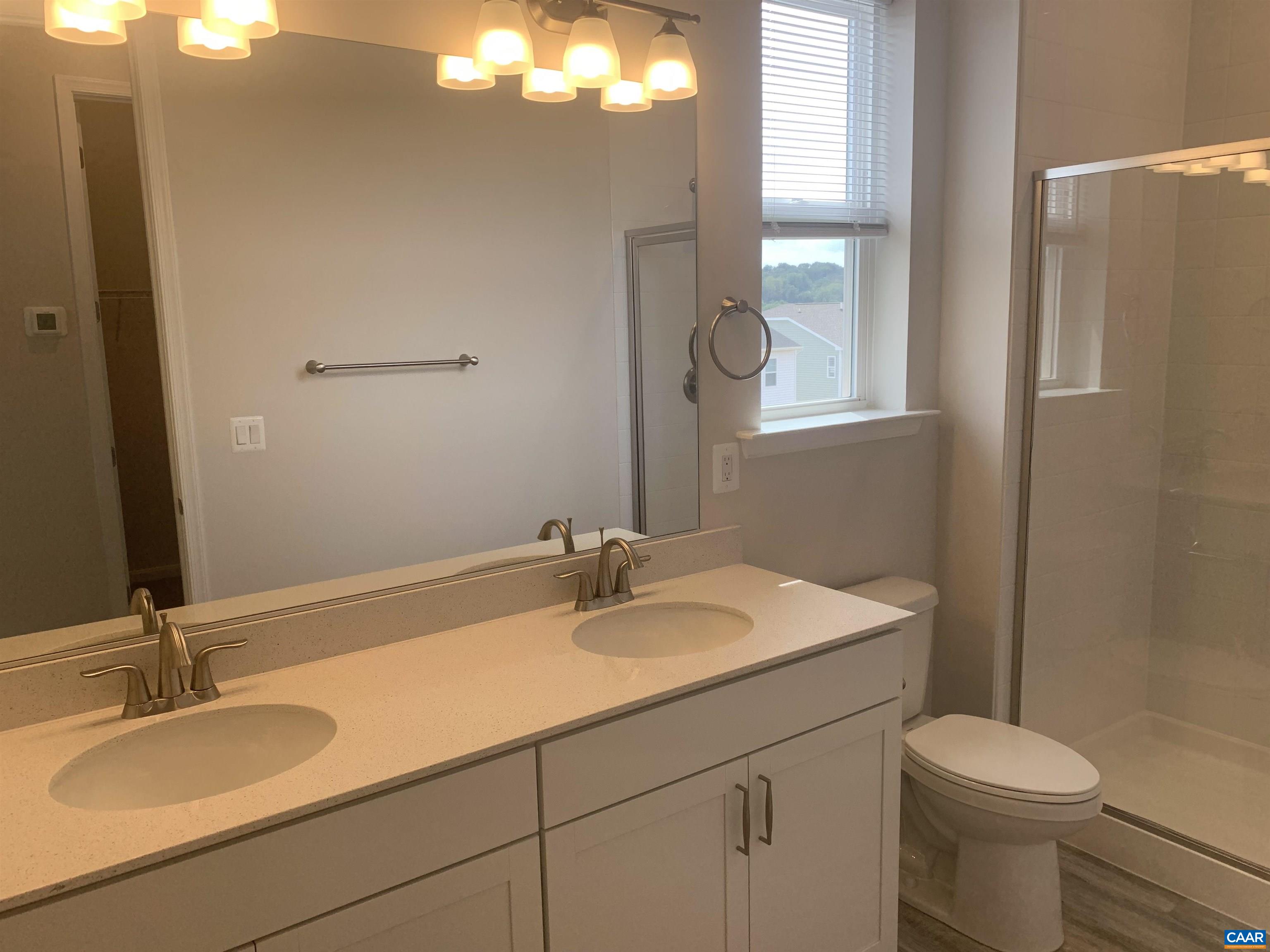 758 Round Hill Road Orange, VA 22960 - Photo 16 of 23 a bathroom with a sink toilet and mirror