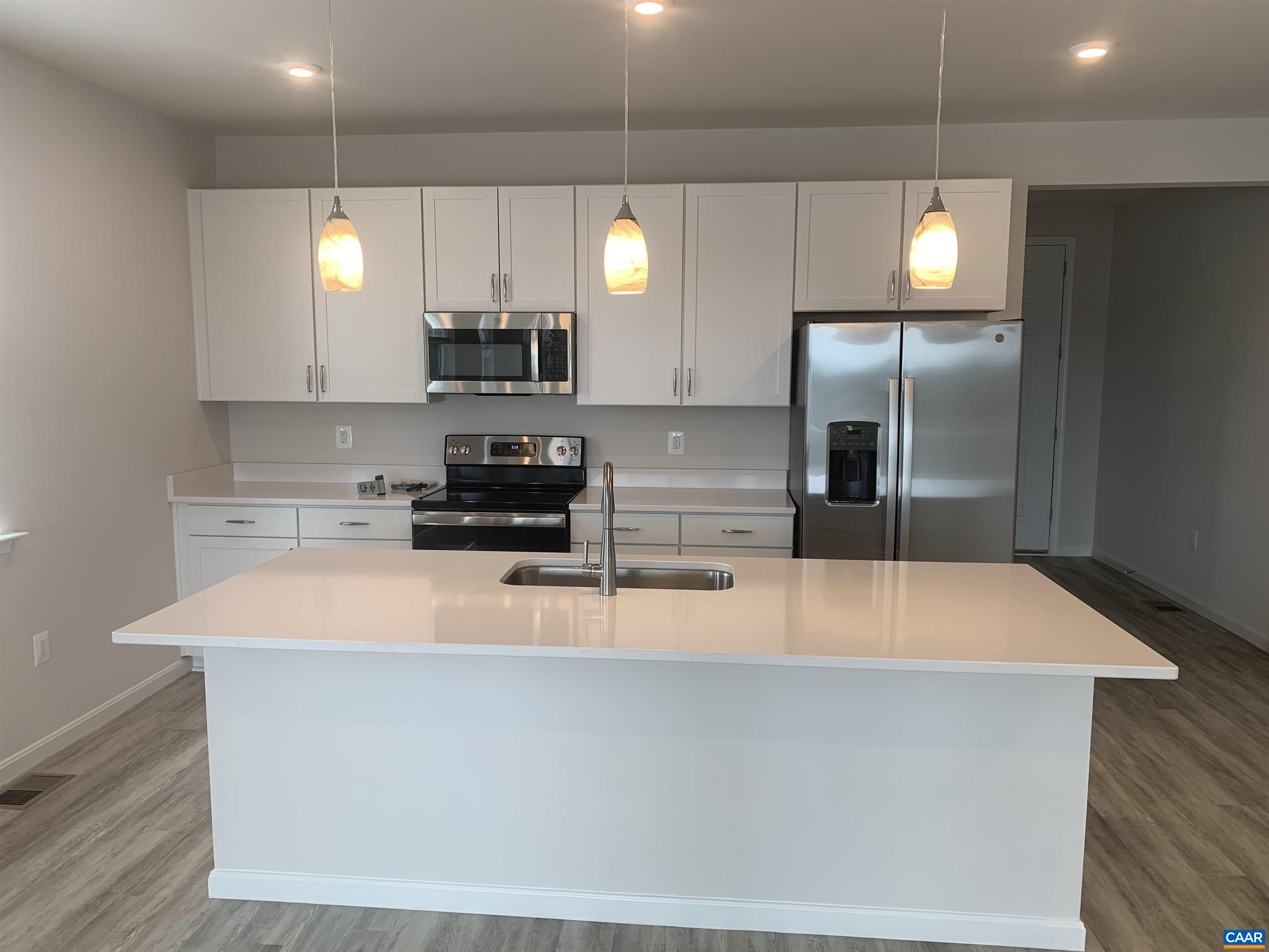 758 Round Hill Road Orange, VA 22960 - Photo 6 of 23 a large white kitchen with kitchen island a sink stainless steel appliances and cabinets