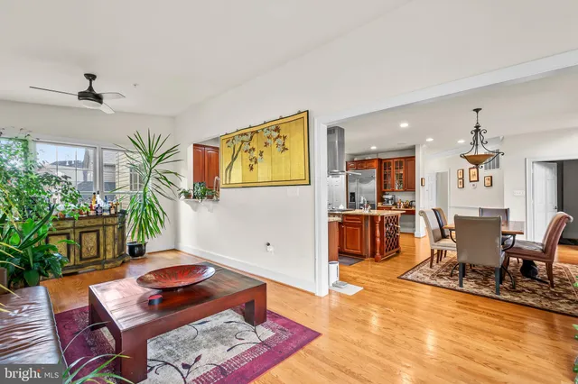 a living room with furniture wooden floor and a window