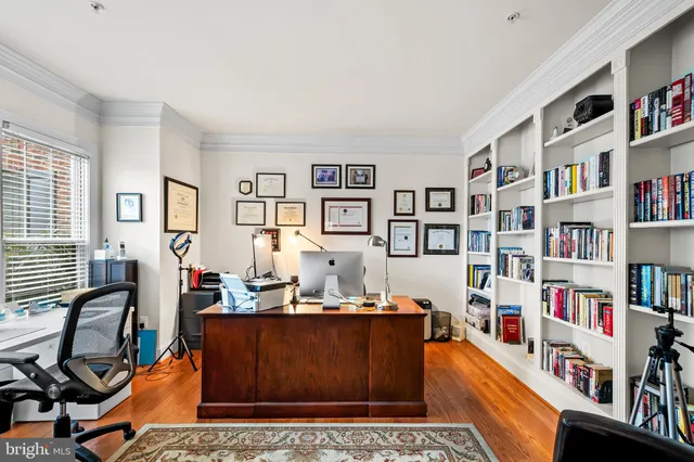 a view of a hallway with wooden floor and stairs