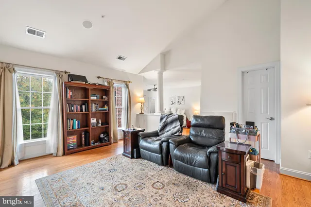 a bedroom with a bed and a flat tv screen on dresser