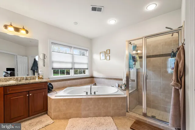 a bathroom with a sink vanity mirror and toilet