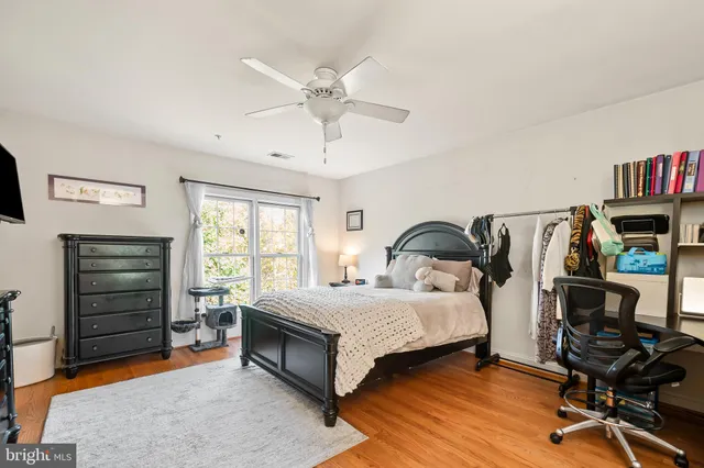 a living room with furniture gym equipment and a flat screen tv