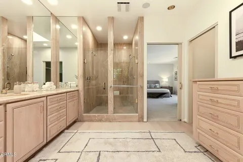 a bathroom with a sink a toilet and a large mirror