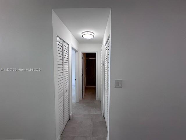 11572 Timbers Way, Unit 11572 Boca Raton, FL 33428 - Photo 17 of 22 a view of a hallway with wooden shelves