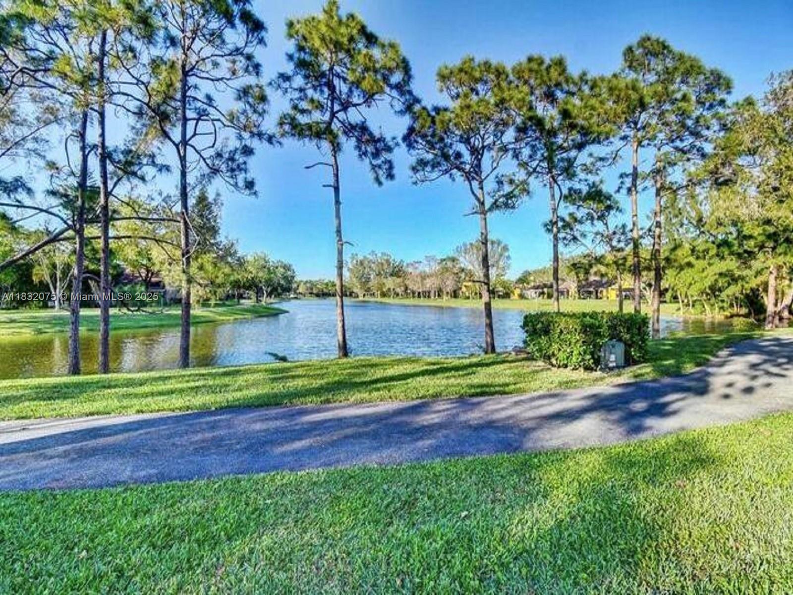 11572 Timbers Way, Unit 11572 Boca Raton, FL 33428 - Photo 20 of 22 a view of a park and trees with a big yard
