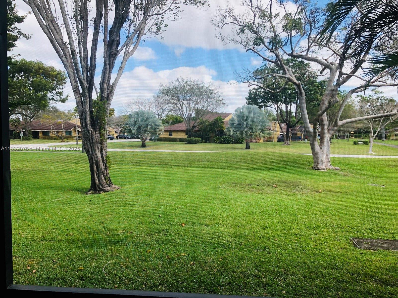 11572 Timbers Way, Unit 11572 Boca Raton, FL 33428 - Photo 21 of 22 a big yard with lots of green space and palm trees