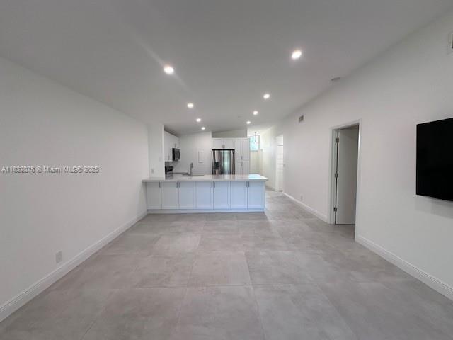 11572 Timbers Way, Unit 11572 Boca Raton, FL 33428 - Photo 3 of 22 a view of a kitchen with a sink and a refrigerator