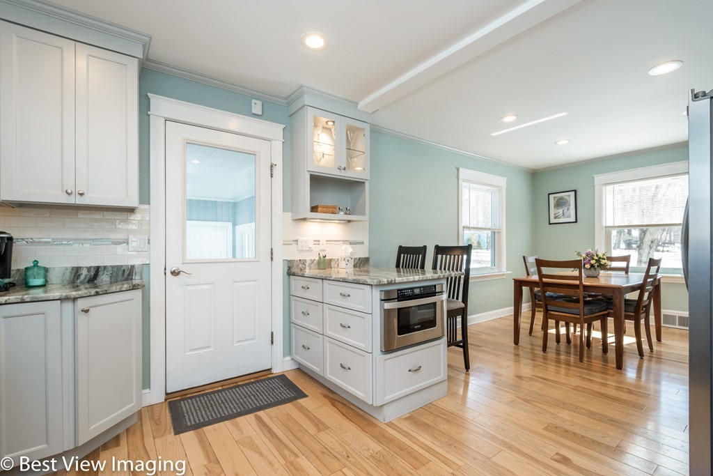 118 Goldthwaite Road Northbridge, MA 01588 - Photo 11 of 24 a kitchen with stainless steel appliances white cabinets and wooden floor