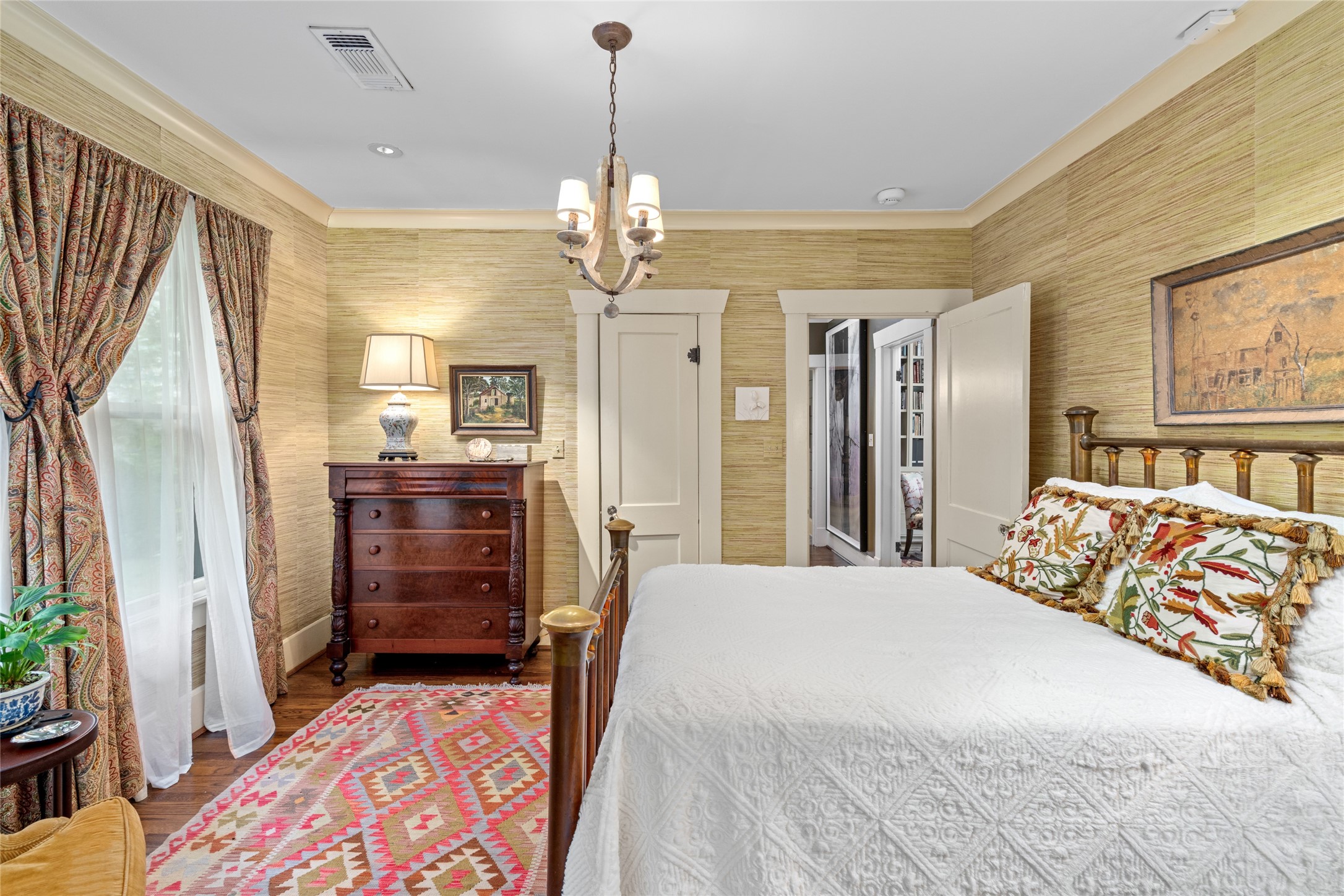 4502 Stanford Street Houston, TX 77006 - Photo 24 of 39 a spacious bedroom with a bed and wooden floor