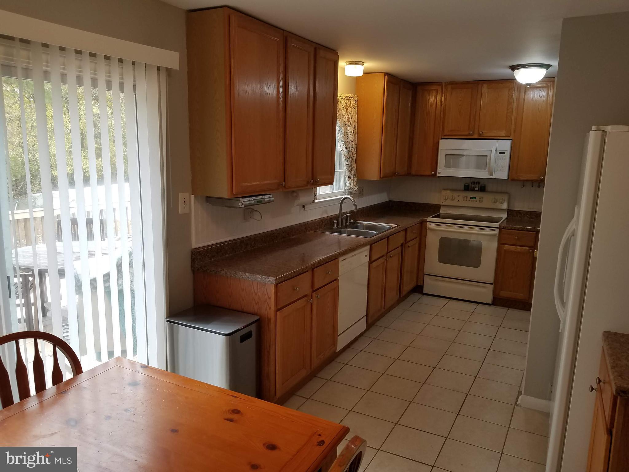 6955 Conservation Drive Springfield, VA 22153 - Photo 16 of 42 Kitchen with sliding doors that lead to large deck