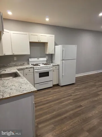 a kitchen with a stove a sink and a refrigerator